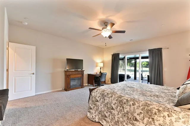 a spacious bedroom with a bed and a chandelier