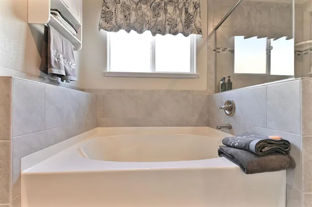 a bedroom with a bed and a flat tv screen