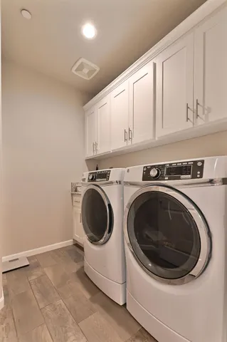a view of a house with a small yard and wooden fence