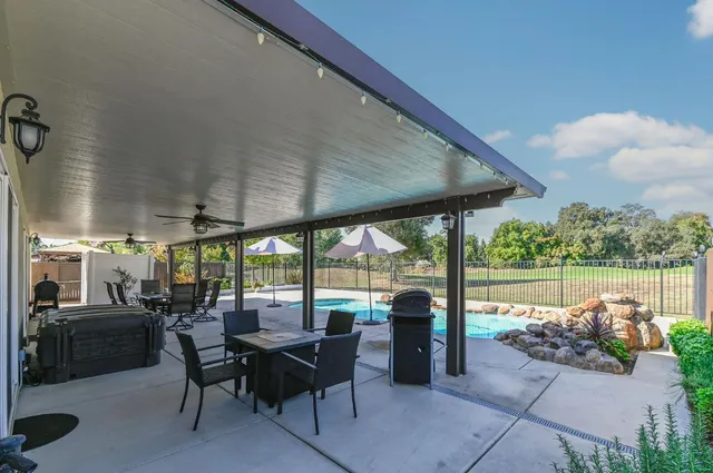 a view of a house with a small yard and wooden fence