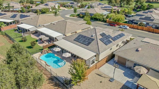 a backyard of a house with table and chairs