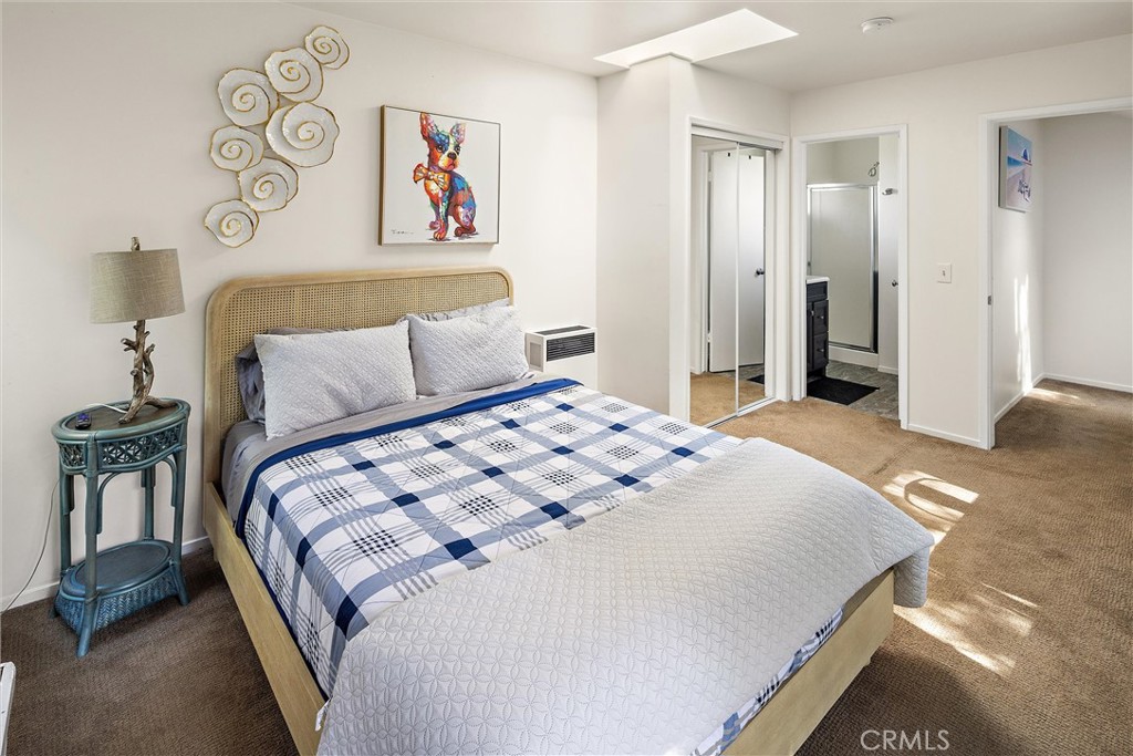 1361 Haddon Drive Cambria, CA 93428 - Photo 16 of 23 a bedroom with a bed and a painting on the wall