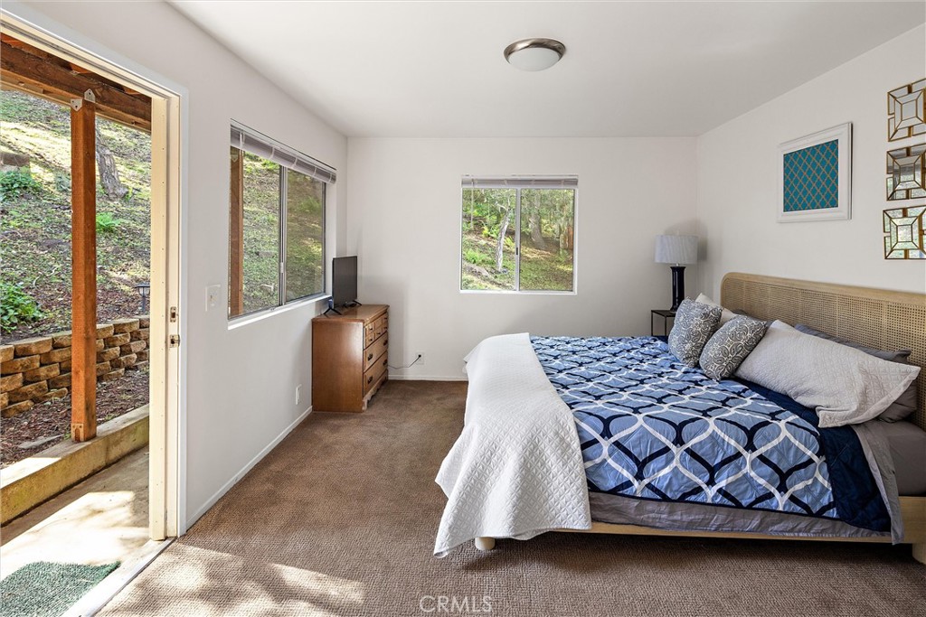 1361 Haddon Drive Cambria, CA 93428 - Photo 18 of 22 a bedroom with a bed and window
