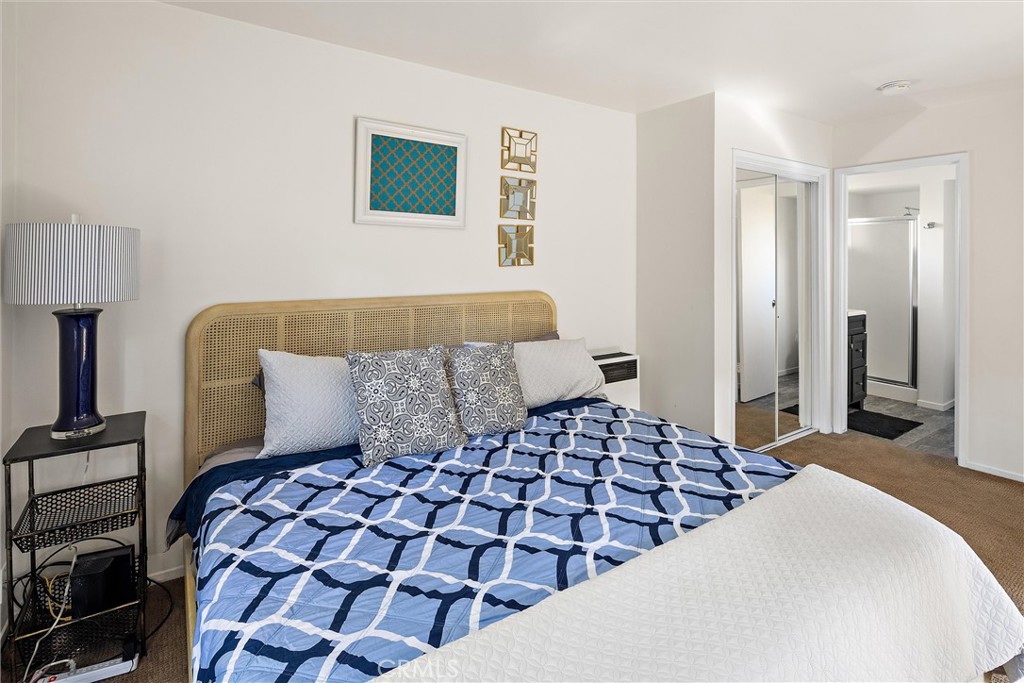 1361 Haddon Drive Cambria, CA 93428 - Photo 19 of 22 a bedroom with a large bed and a lamp