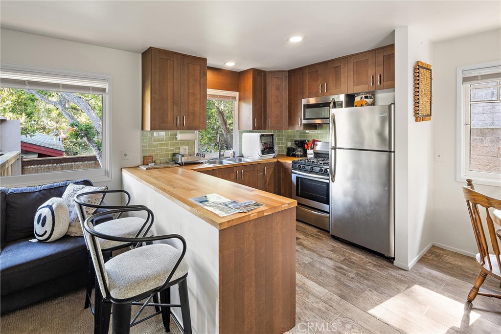 1361 Haddon Drive Cambria, CA 93428 - Photo 3 of 23 a kitchen with a refrigerator a stove a sink and a refrigerator