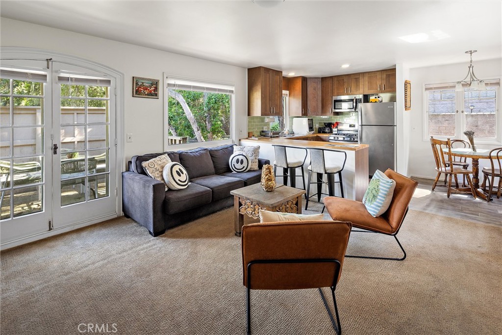 1361 Haddon Drive Cambria, CA 93428 - Photo 8 of 23 a living room with furniture and a large window with kitchen view