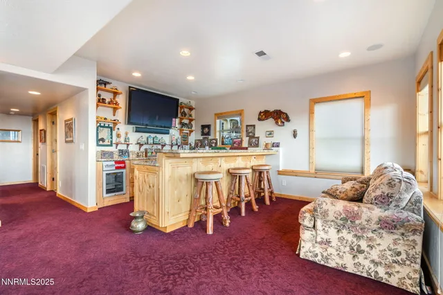 a living room with furniture and a kitchen