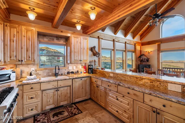 a kitchen with sink a window and cabinets