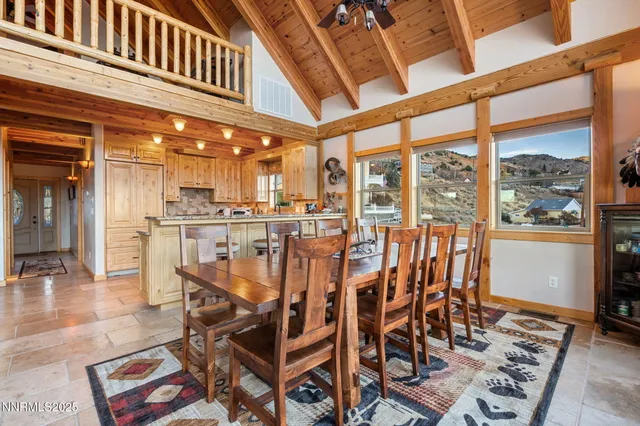 a dining room with furniture a rug and wooden floor