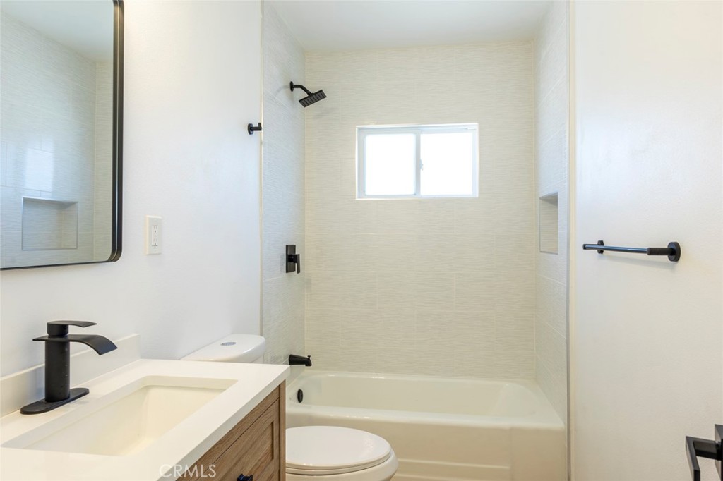 1218 6th Street Redlands, CA 92374 - Photo 11 of 16 a bathroom with a granite countertop sink toilet and shower