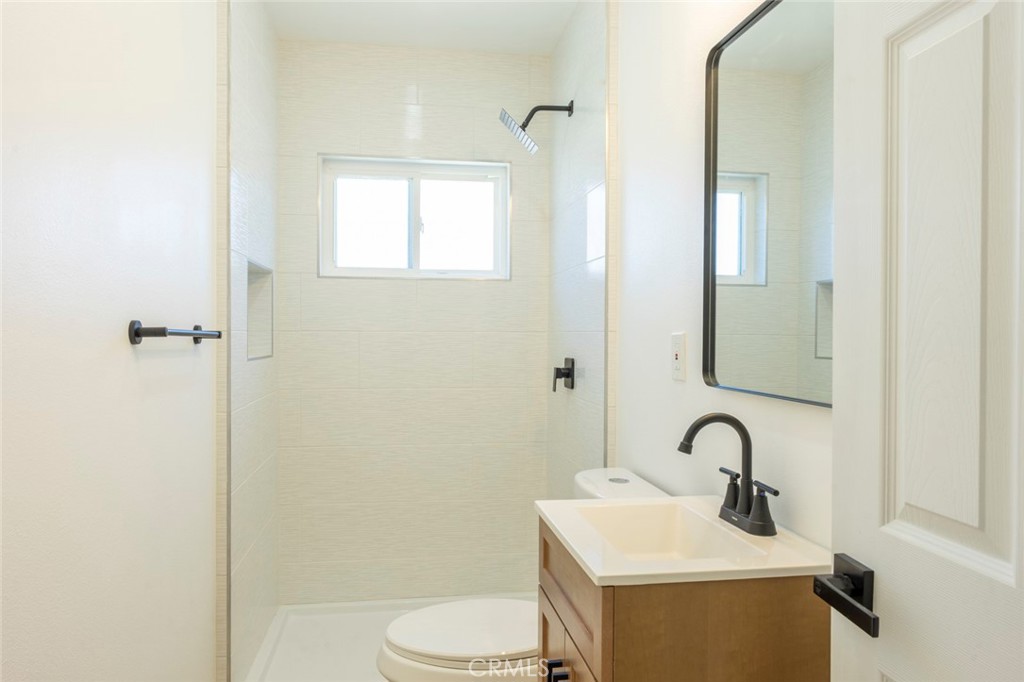 1218 6th Street Redlands, CA 92374 - Photo 12 of 16 a bathroom with a sink toilet and shower
