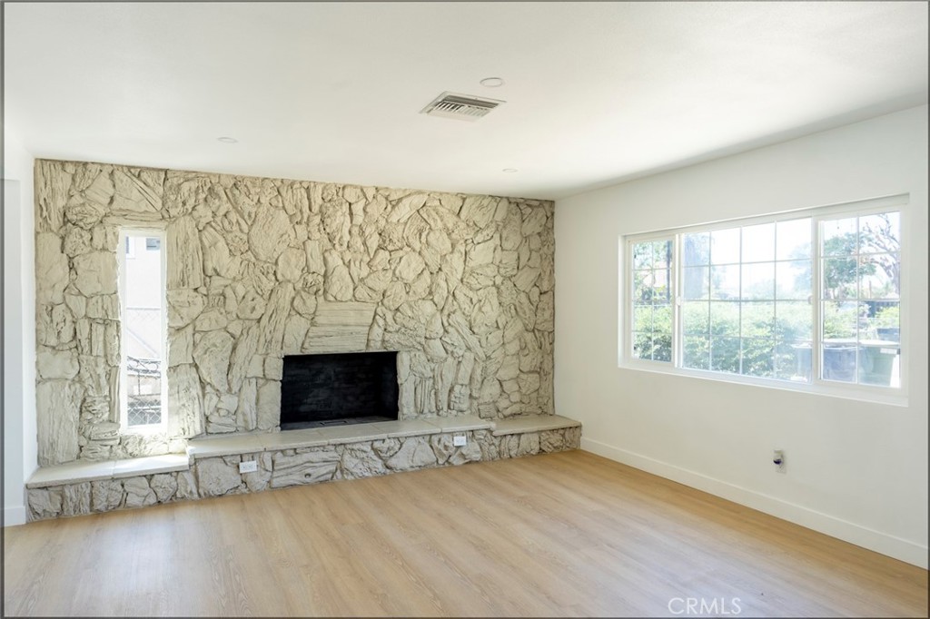 1218 6th Street Redlands, CA 92374 - Photo 2 of 16 an empty room with fireplace and windows