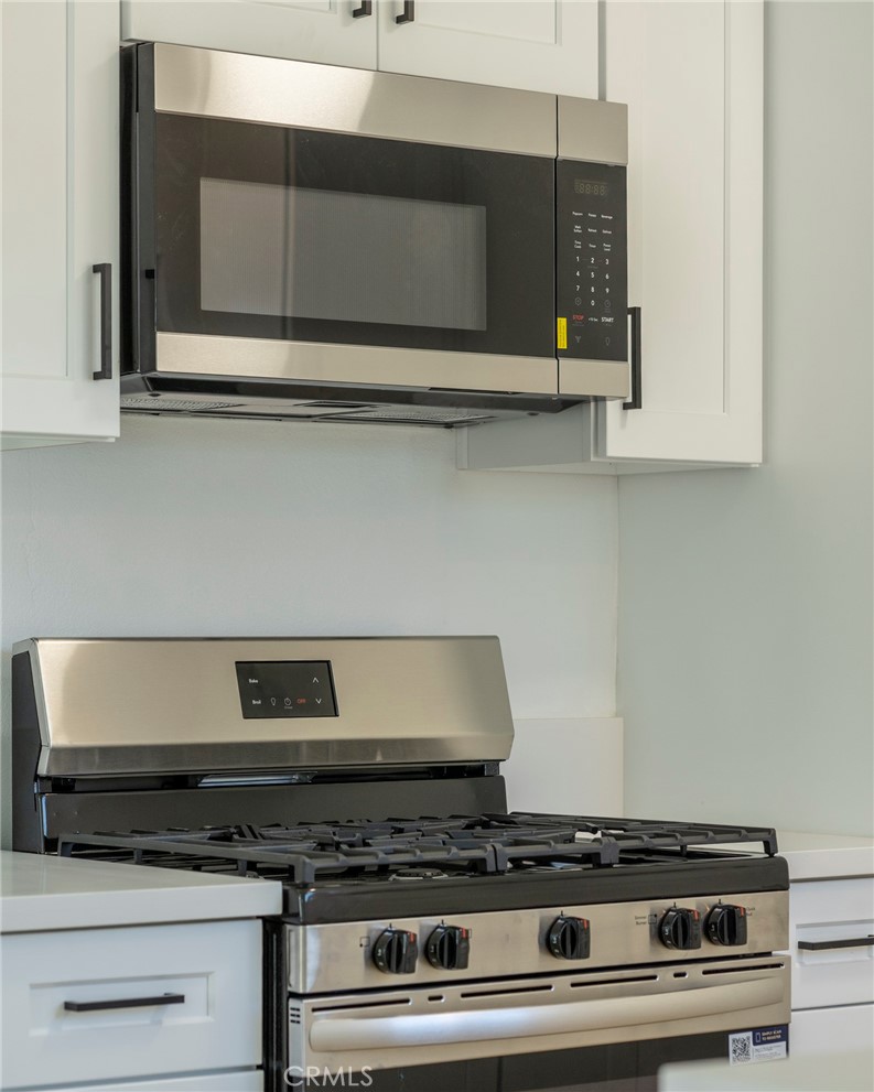 1218 6th Street Redlands, CA 92374 - Photo 6 of 16 a stove top oven sitting inside of a kitchen