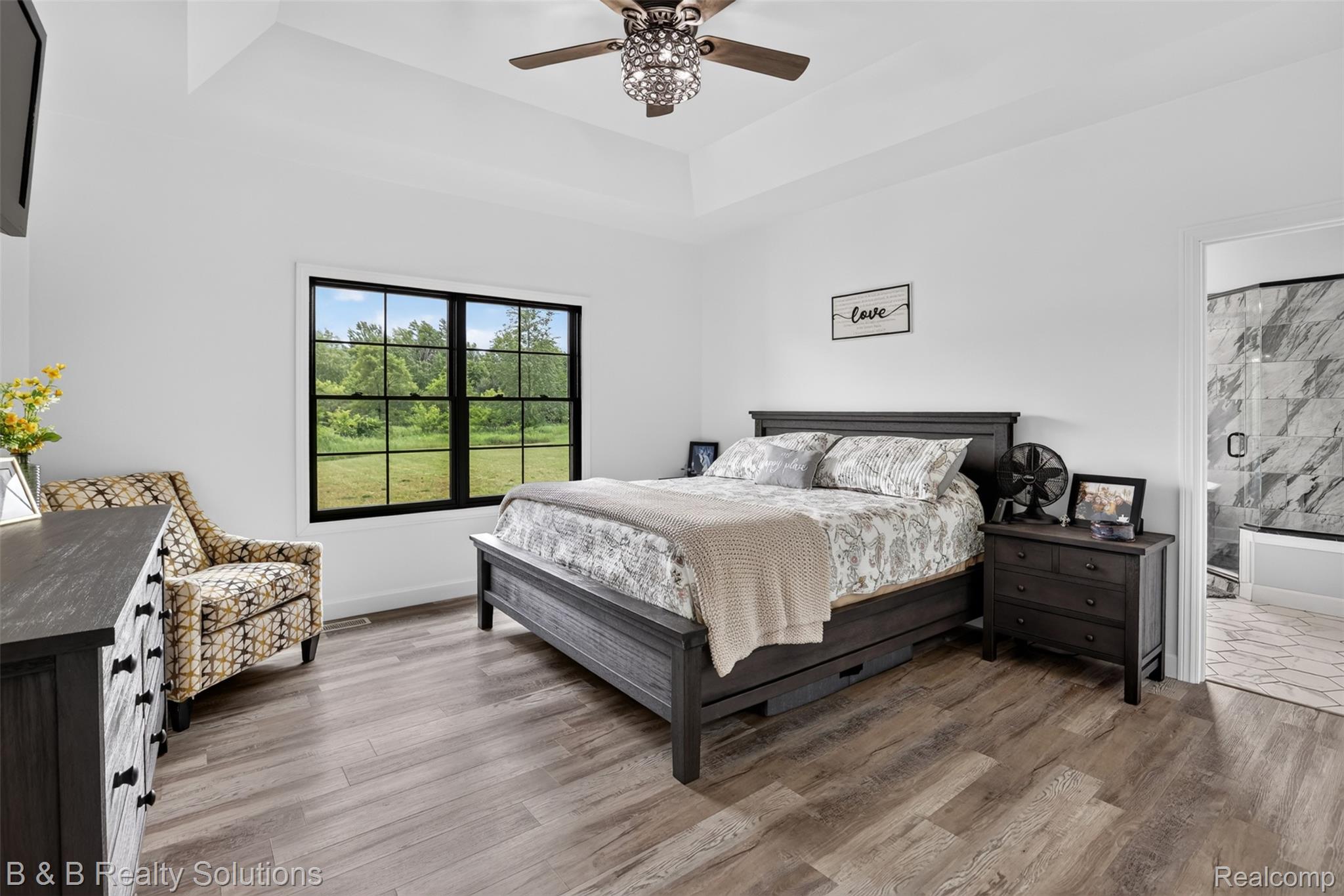 6204 Fish Lake Road North Branch, MI 48461 - Photo 18 of 79 Spacious bedroom with wood-finish flooring, a tray ceiling, and a decorative ceiling fan