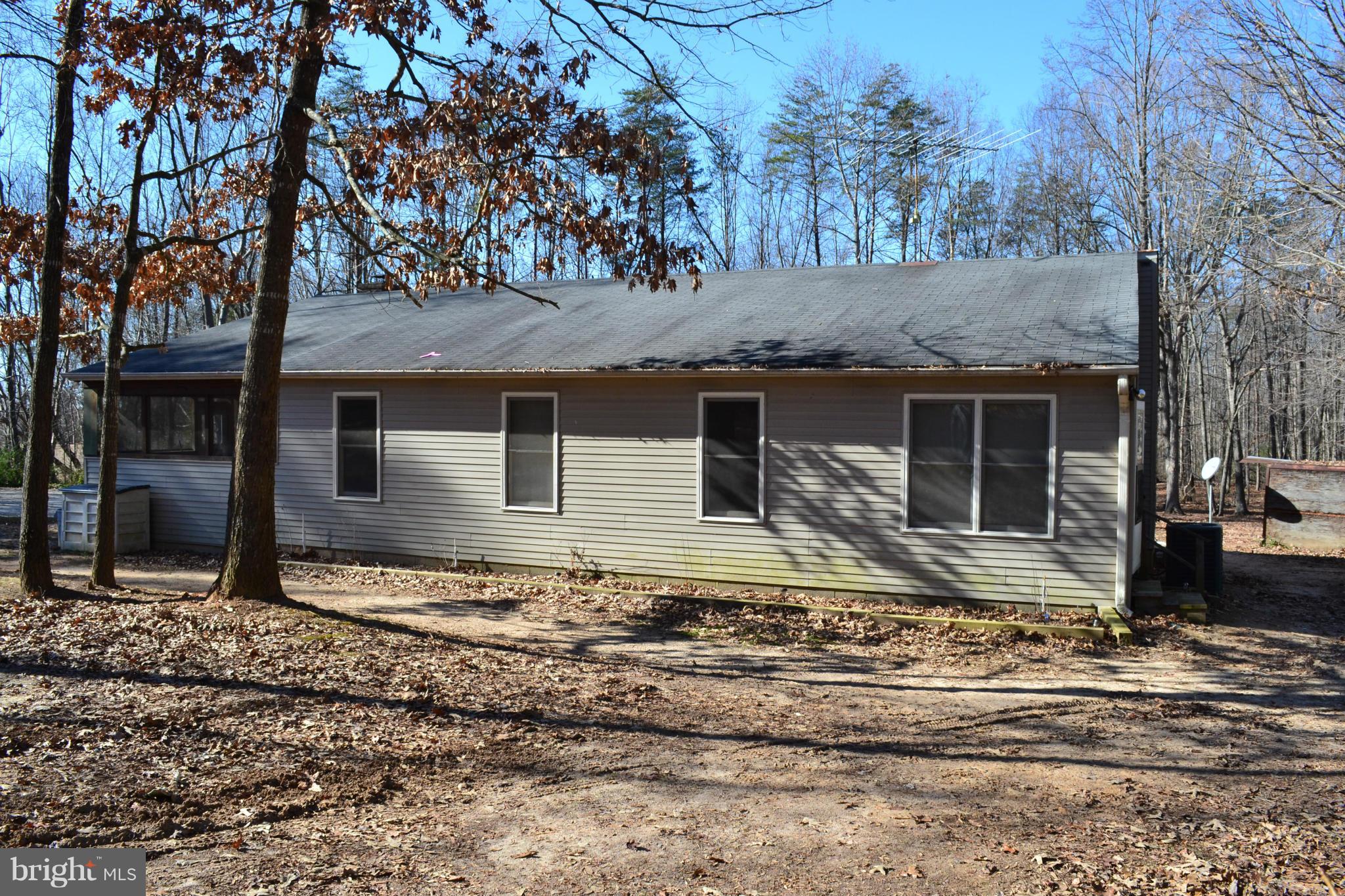 3232 Winding Road Partlow, VA 22534 - Photo 3 of 8 a front view of a house with a garden