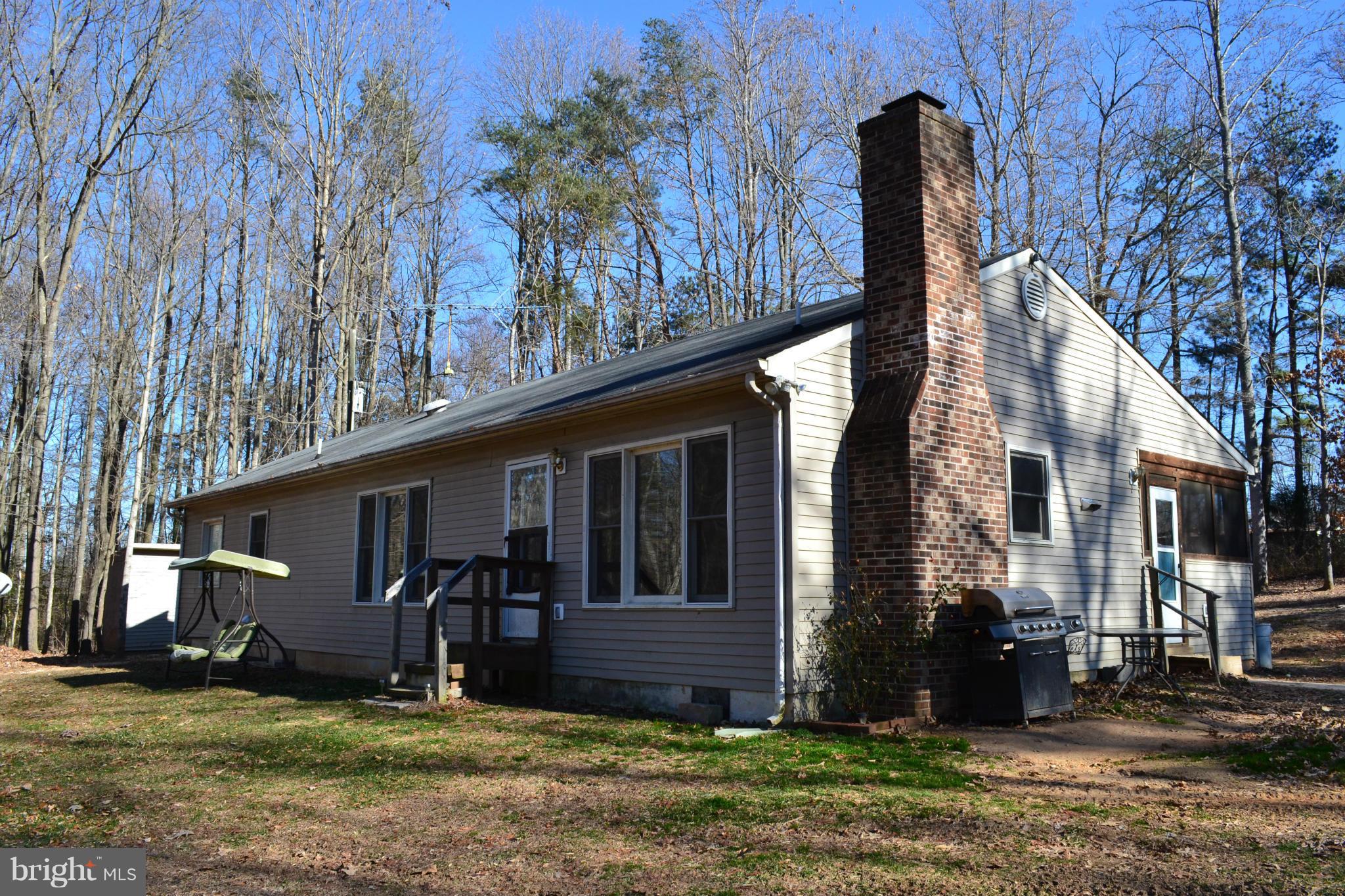 3232 Winding Road Partlow, VA 22534 - Photo 6 of 8 a front view of a house with garden
