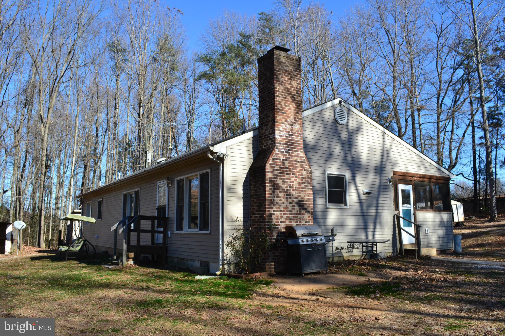 3232 Winding Road Partlow, VA 22534 - Photo 8 of 8 a front view of a house with a yard