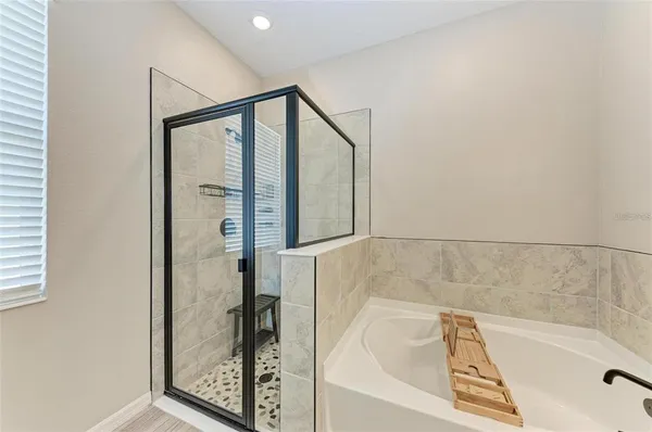a bathroom with a tub and shower