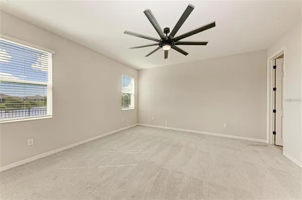 a view of a big room with wooden floor and windows in a room