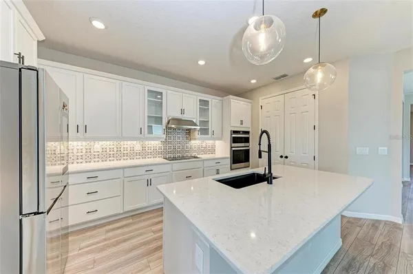 a kitchen with stainless steel appliances a stove sink and cabinets