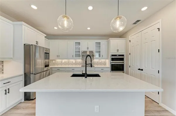 a kitchen with stainless steel appliances a refrigerator and a stove