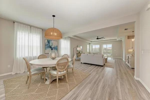 a view of a dining room with furniture wooden floor and chandelier