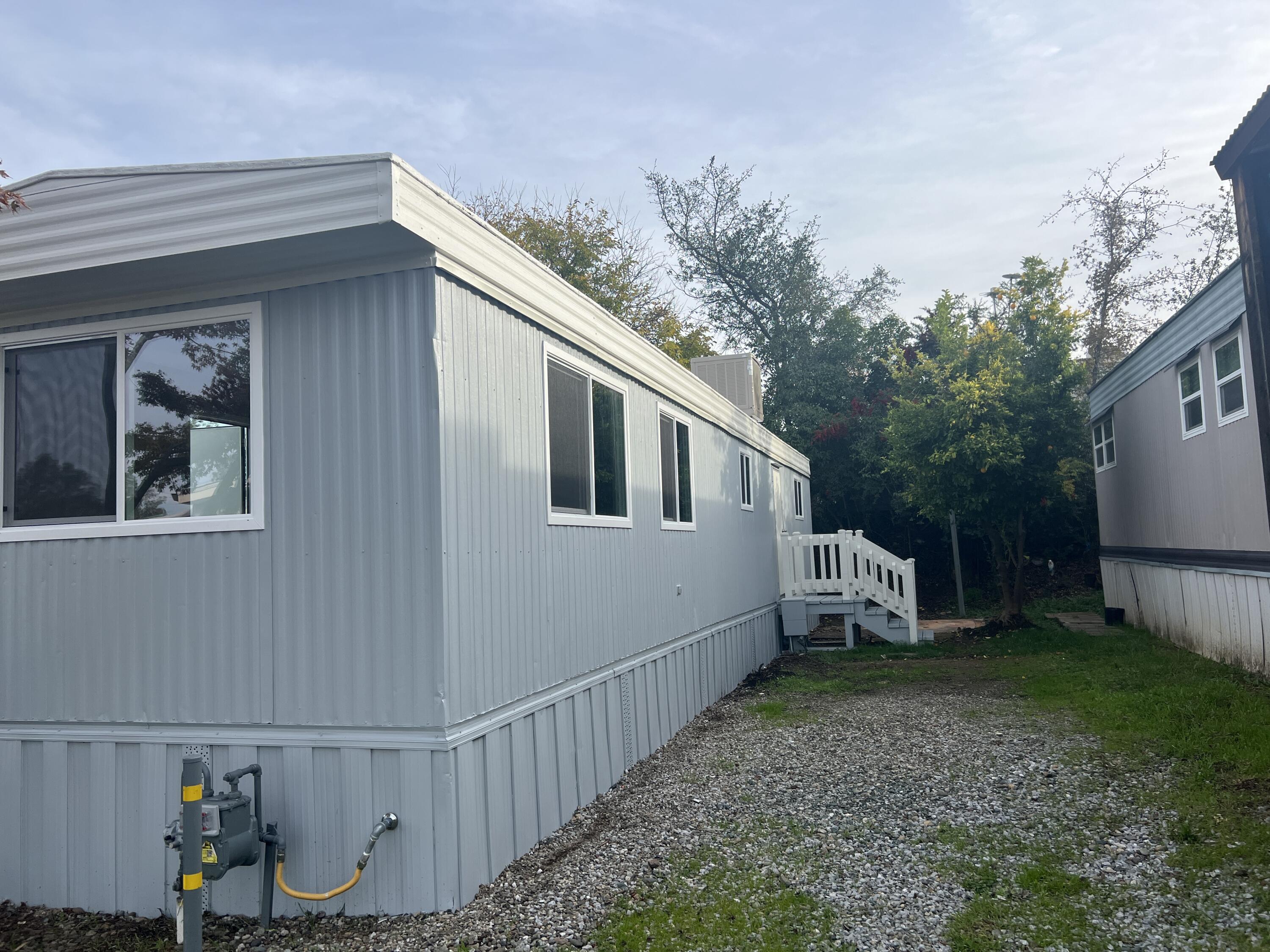 481 Twin View Boulevard, Unit 97 Redding, CA 96003 - Photo 11 of 13 a view of a house with backyard and trees