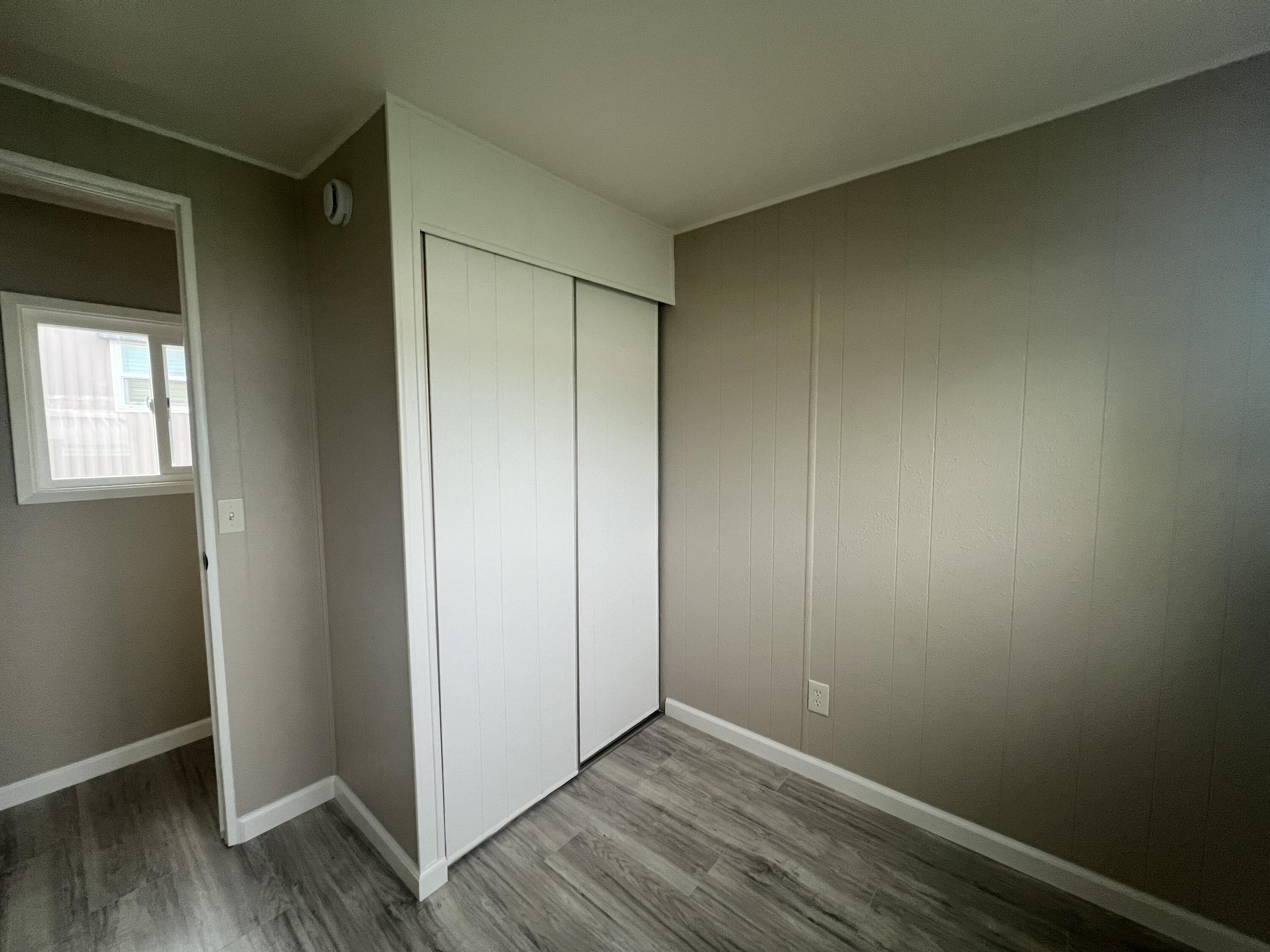481 Twin View Boulevard, Unit 97 Redding, CA 96003 - Photo 7 of 13 an empty room with wooden floor and closet