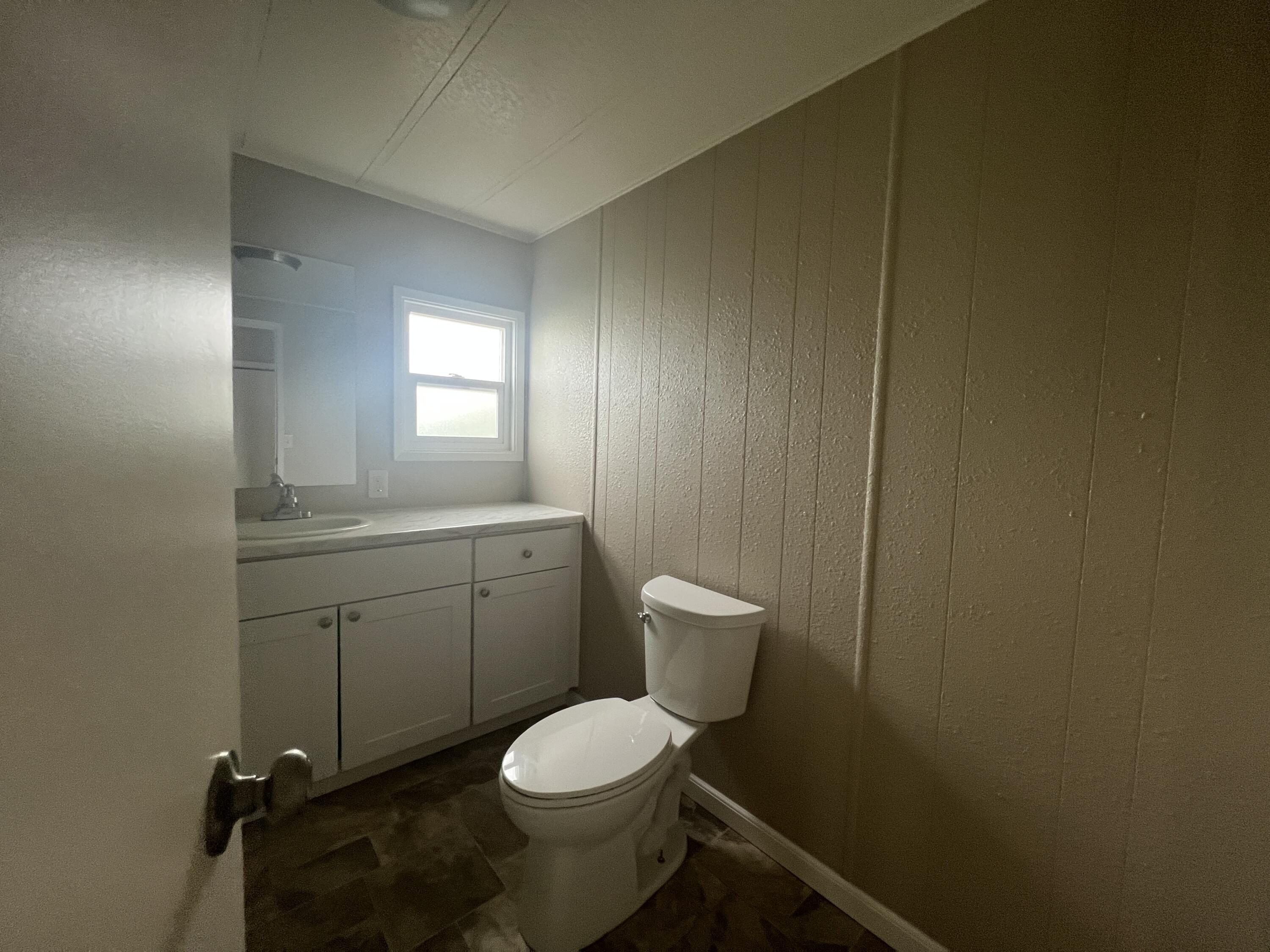 481 Twin View Boulevard, Unit 97 Redding, CA 96003 - Photo 8 of 13 a bathroom with a toilet a sink and mirror