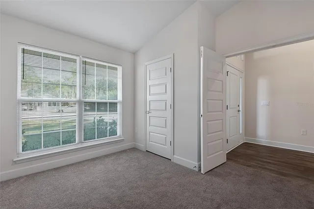 a view of a room with wooden floor chandelier and window