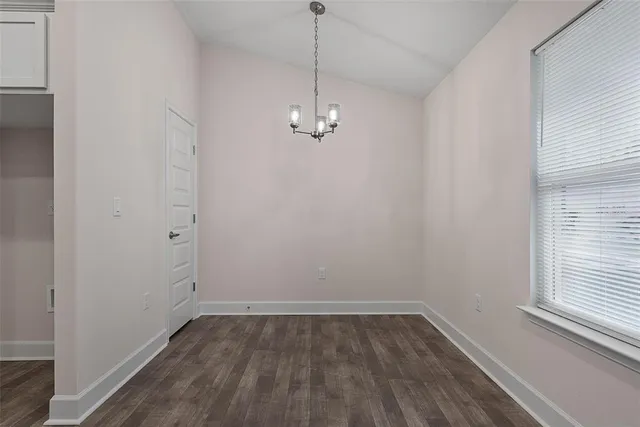 a kitchen with stainless steel appliances granite countertop a stove and a white cabinets