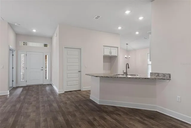 wooden floor in an empty room with a fan