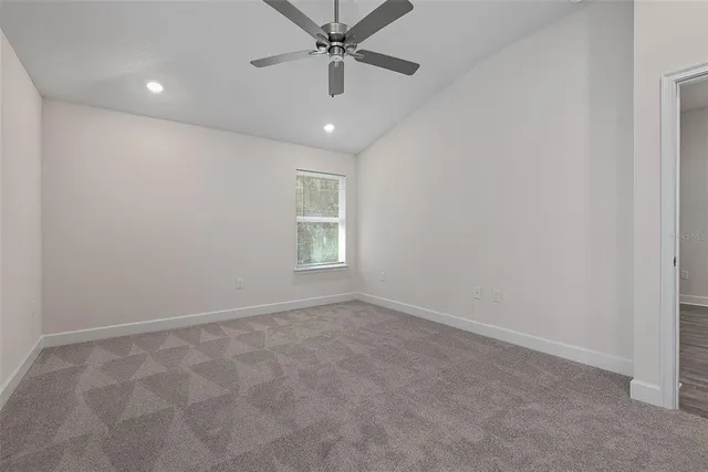 a bathroom with a granite countertop sink a toilet and a large mirror