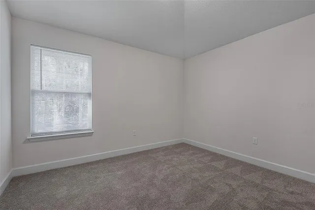 a bathroom with a granite countertop sink mirror vanity and toilet