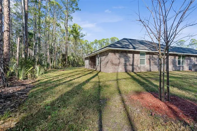 a view of outdoor space with sliding door and tree in the background