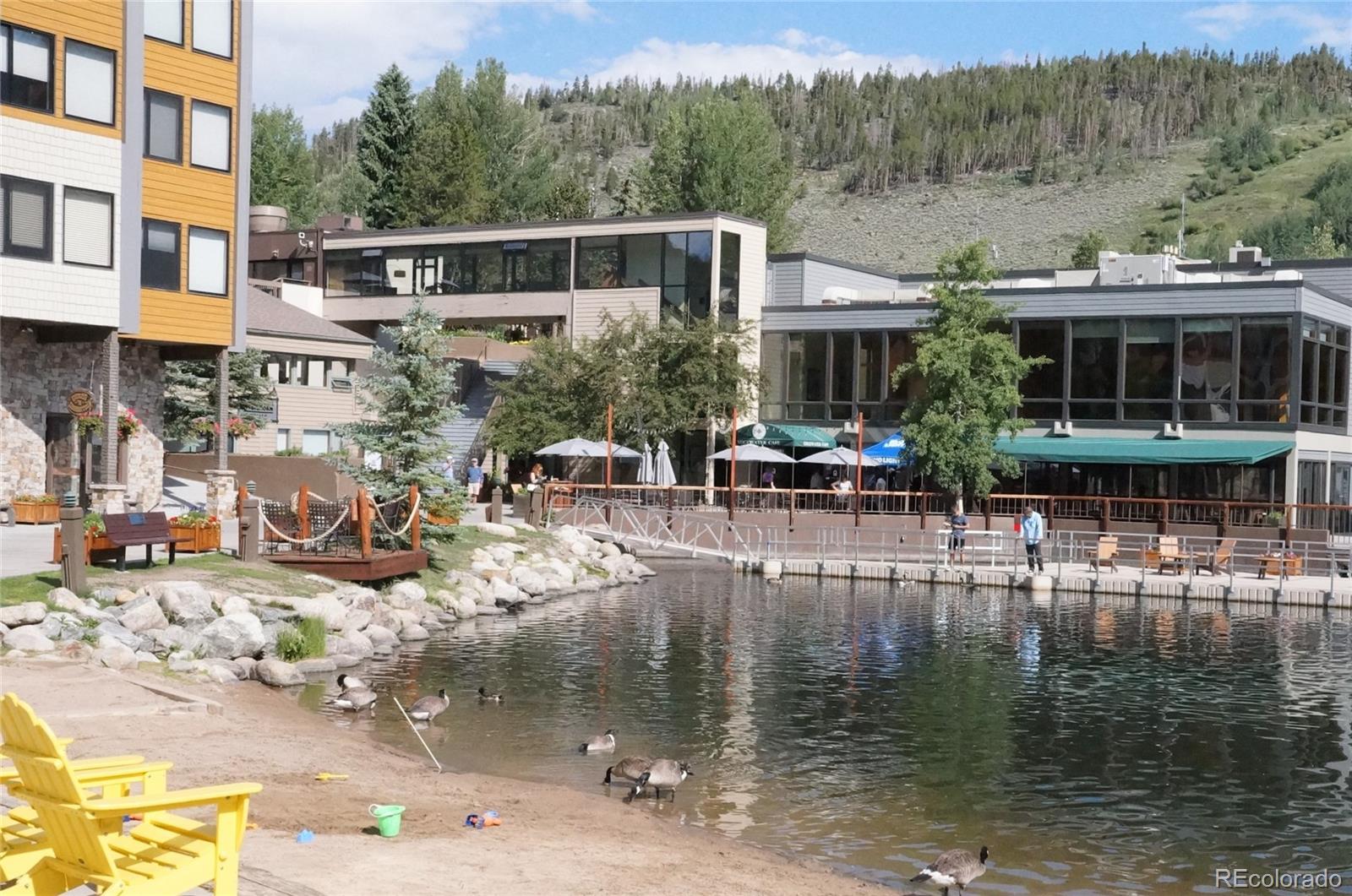 373 Wild Irishman Road, Unit 1071 Dillon, CO 80435 - Photo 19 of 19 a view of a lake with a patio and a yard