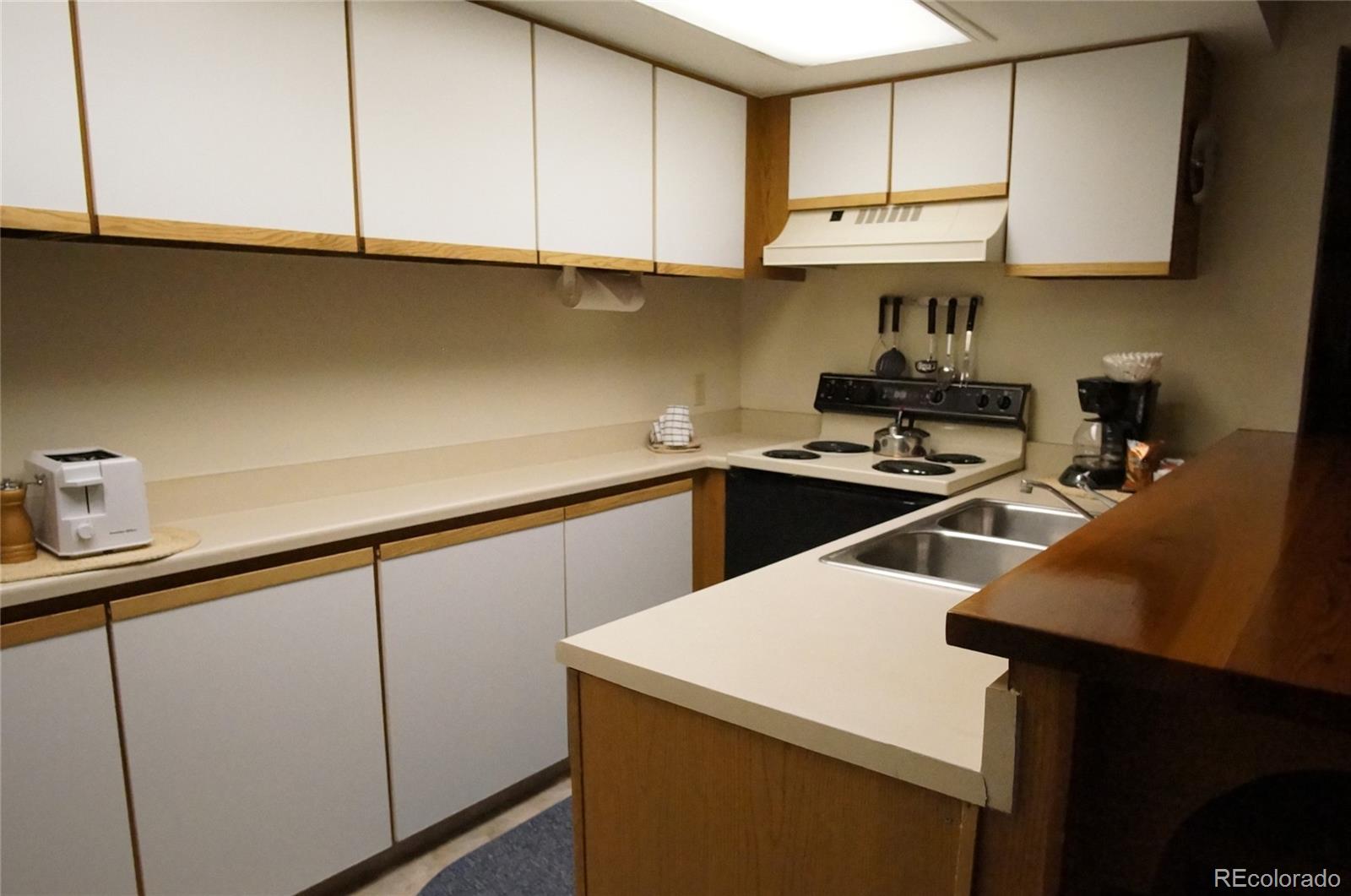 373 Wild Irishman Road, Unit 1071 Dillon, CO 80435 - Photo 6 of 19 a kitchen with a sink a stove and cabinets