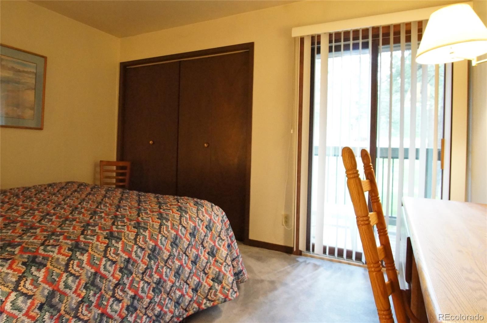 373 Wild Irishman Road, Unit 1071 Dillon, CO 80435 - Photo 9 of 19 a bedroom with a bed and a dresser