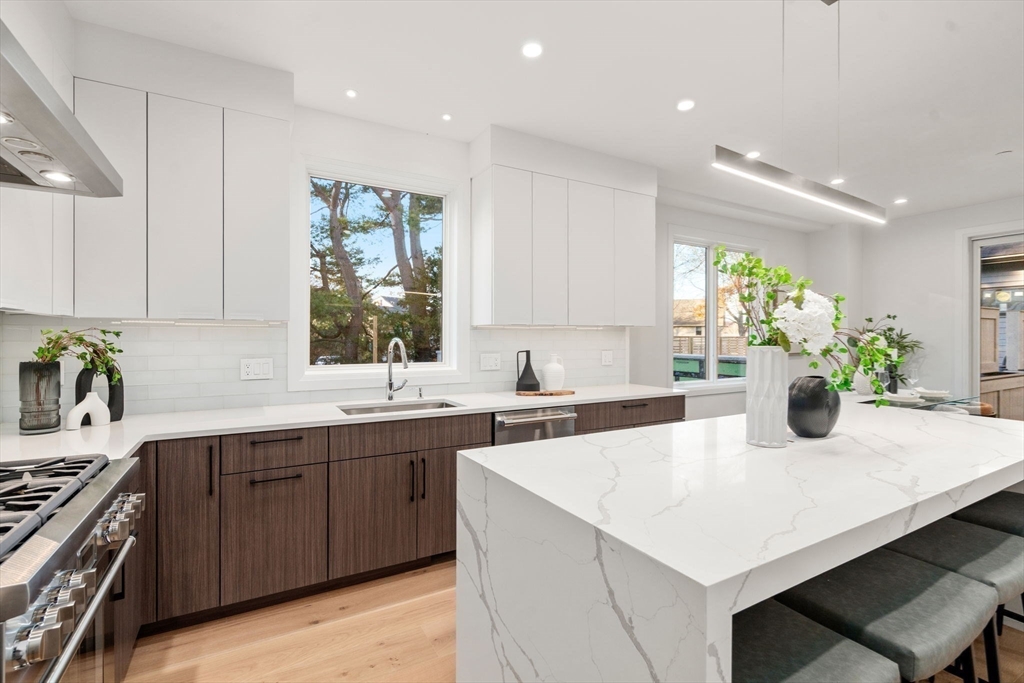 956 Walnut Street, Unit 7 Newton, MA 02459 - Photo 12 of 32 a kitchen with a stove a sink and a refrigerator