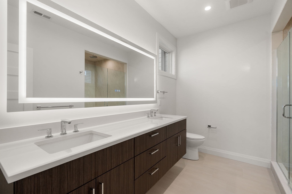 956 Walnut Street, Unit 7 Newton, MA 02459 - Photo 14 of 32 a bathroom with a double vanity sink and a mirror