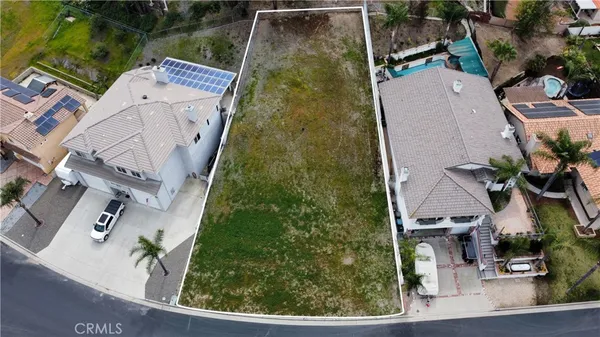 an aerial view of a house with a yard and potted plants