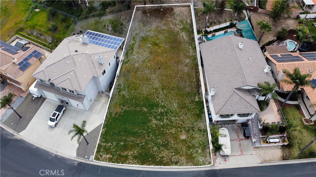 an aerial view of a house with a yard and potted plants