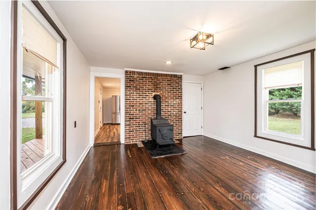 a bathroom with a tub a sink and a large window