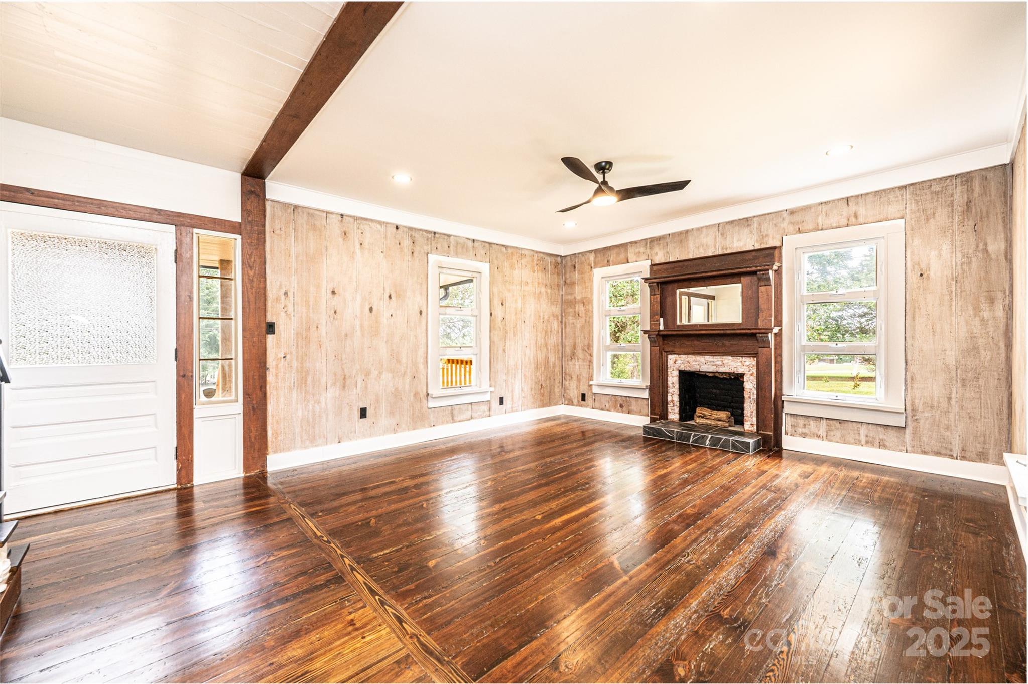 4645 Rifle Range Road Conover, NC 28613 - Photo 15 of 36 a view of empty room with fireplace and wooden floor