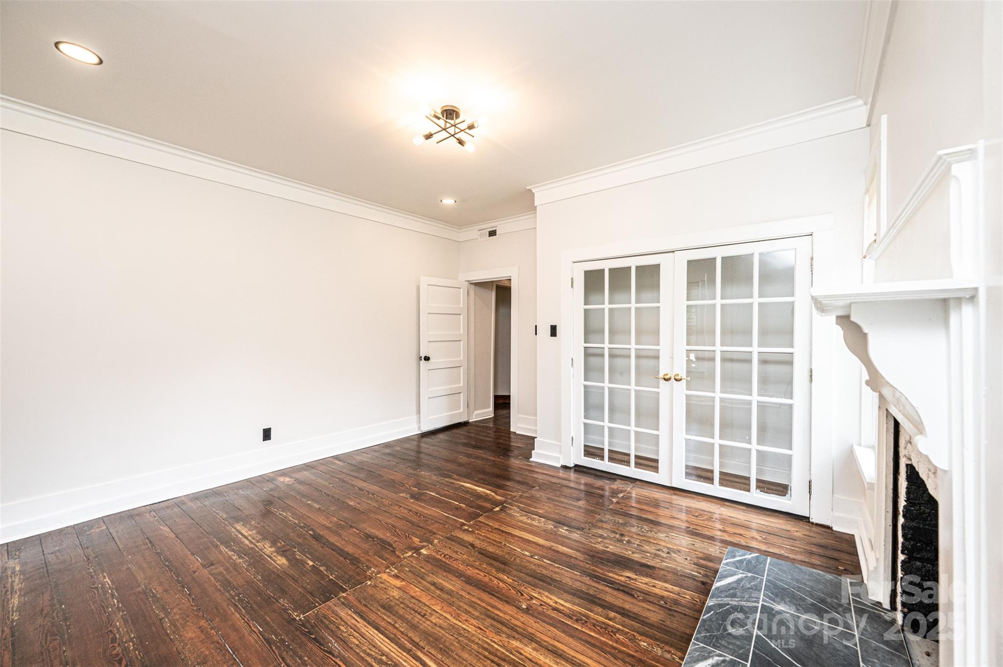 4645 Rifle Range Road Conover, NC 28613 - Photo 18 of 36 an empty room with wooden floor and windows