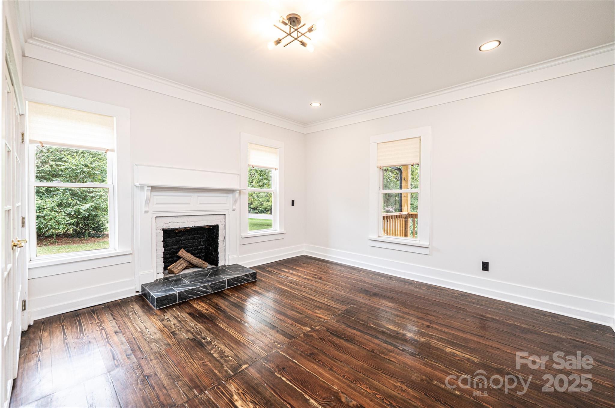 4645 Rifle Range Road Conover, NC 28613 - Photo 19 of 36 a view of empty room with wooden floor and fireplace