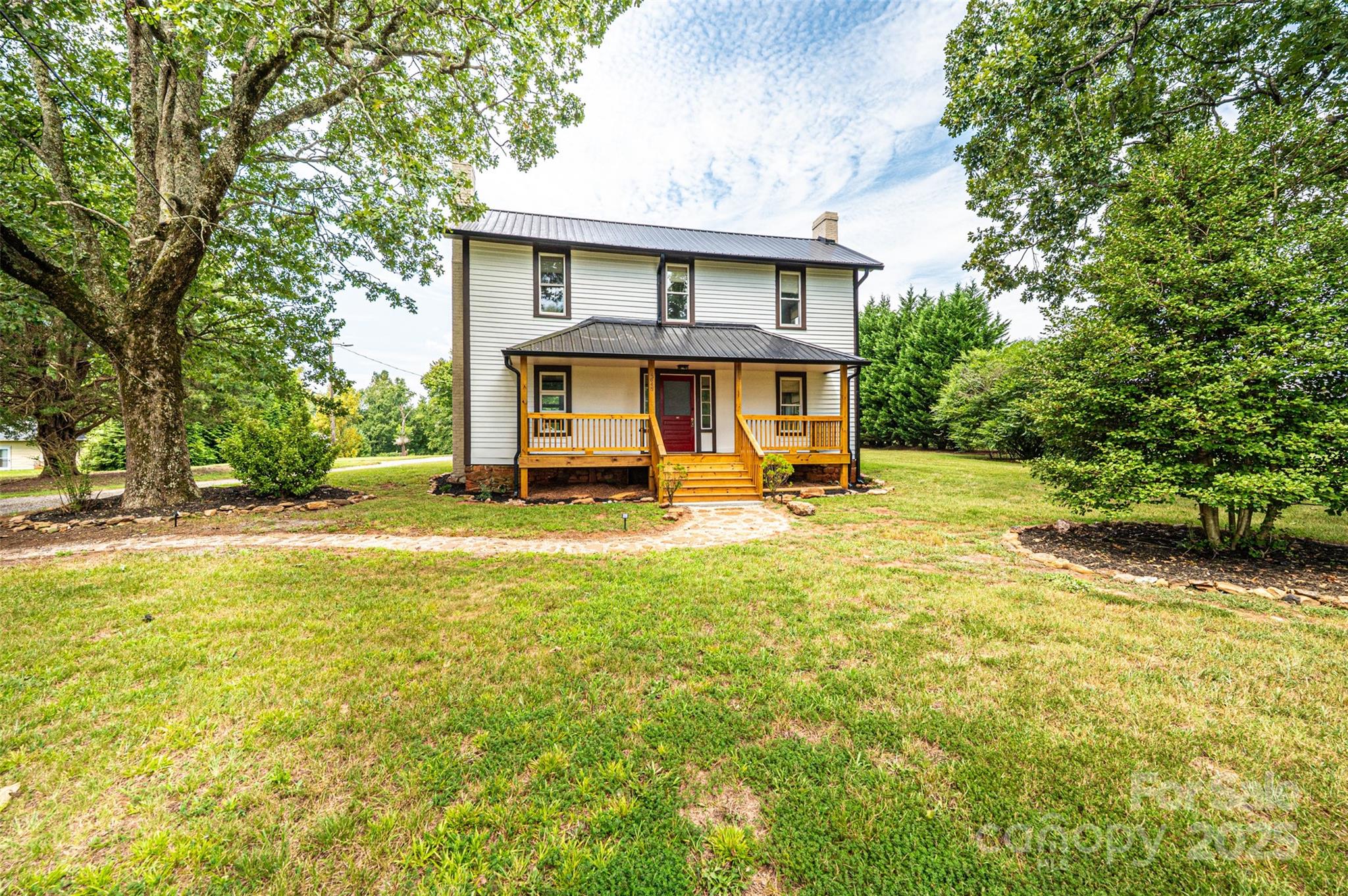 4645 Rifle Range Road Conover, NC 28613 - Photo 2 of 36 a view of house with yard outdoor seating and covered with trees