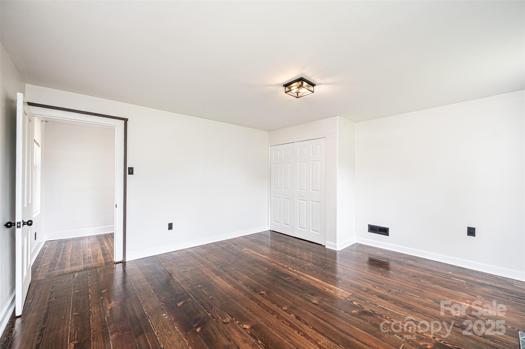 4645 Rifle Range Road Conover, NC 28613 - Photo 22 of 36 an empty room with wooden floor and entrance