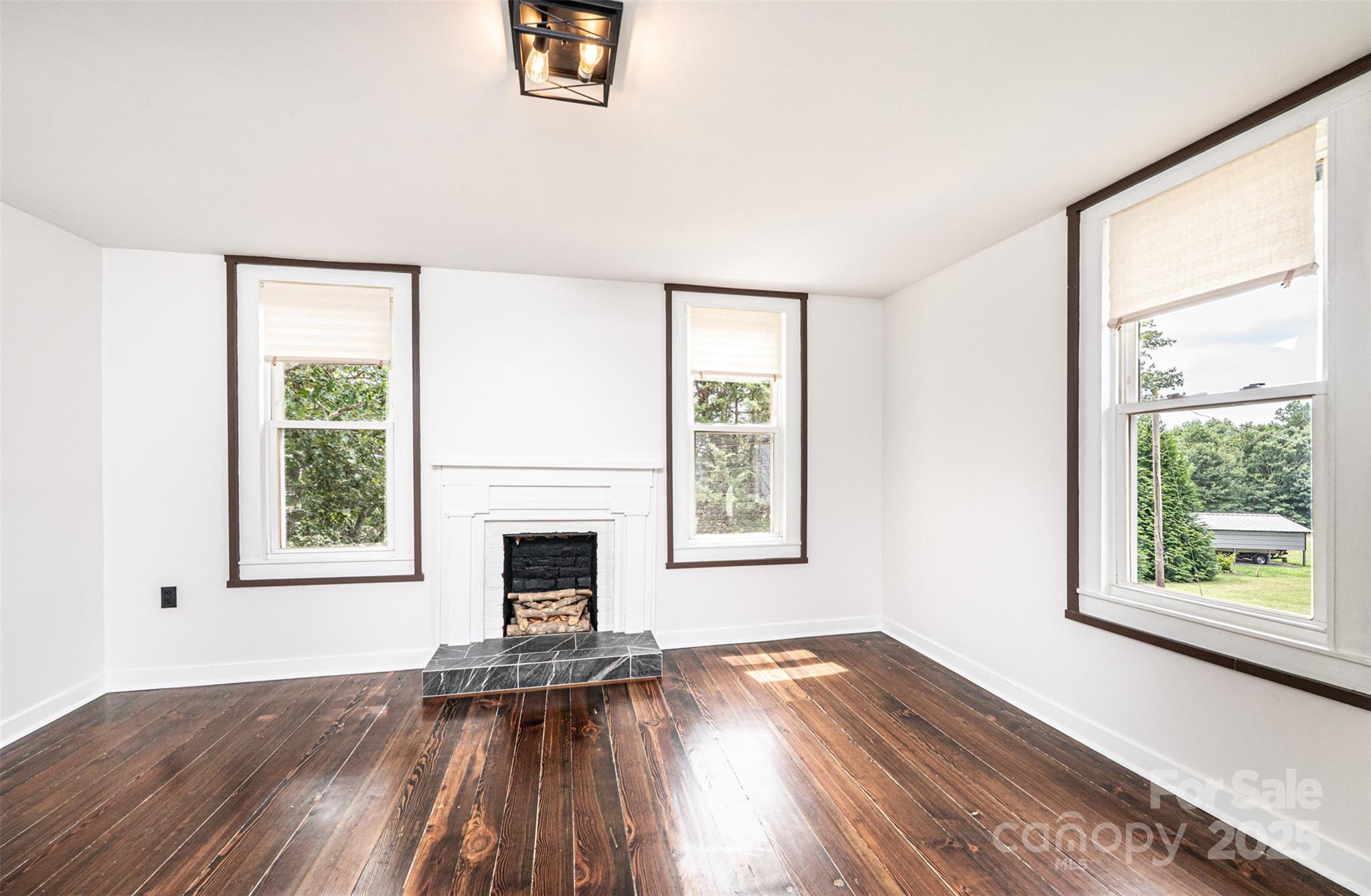 4645 Rifle Range Road Conover, NC 28613 - Photo 24 of 36 a view of an empty room with wooden floor and a window