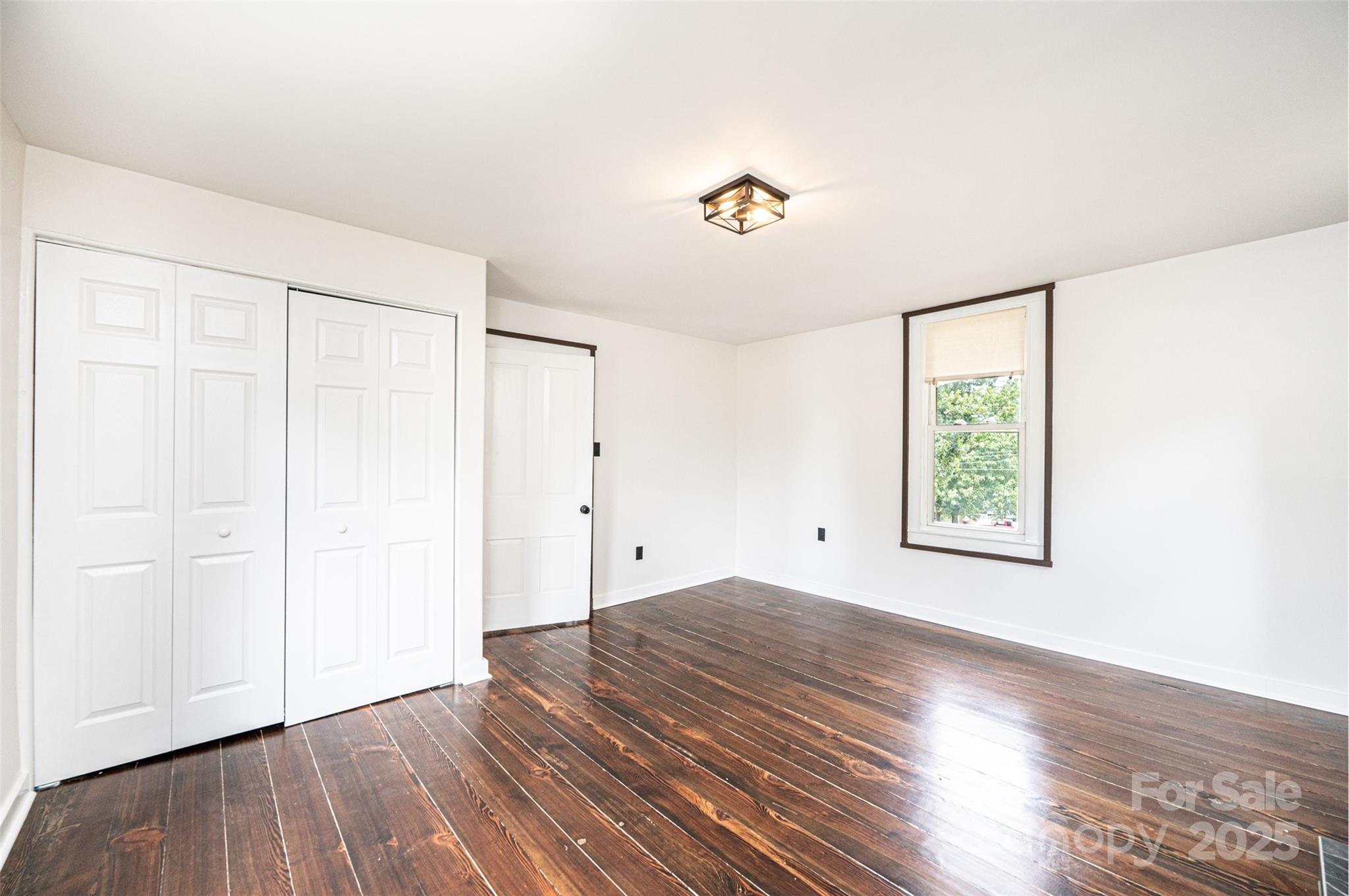 4645 Rifle Range Road Conover, NC 28613 - Photo 25 of 36 an empty room with wooden floor and windows